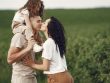 A heartwarming family moment captured in a field, highlighting love and togetherness.